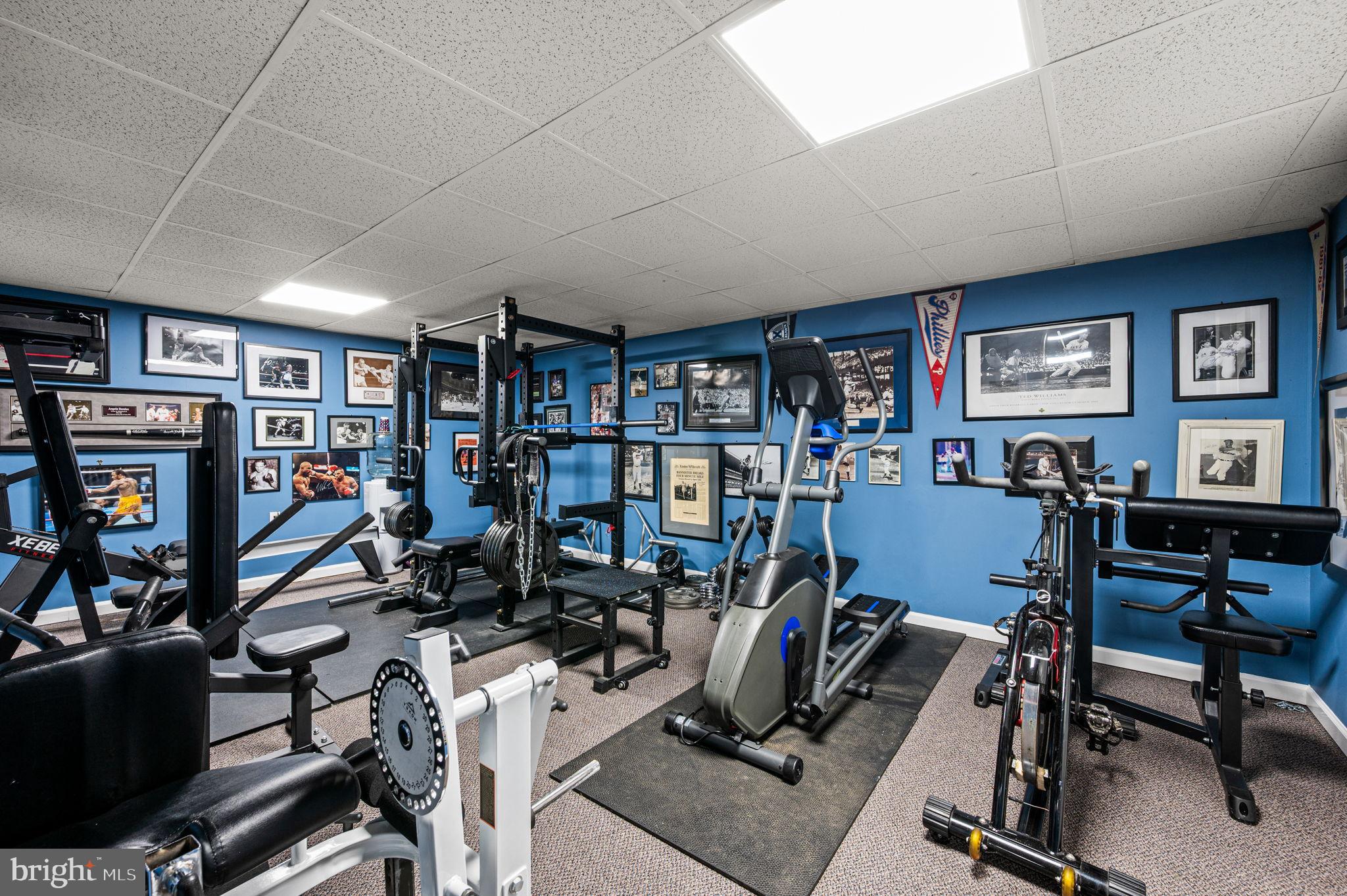650 Willow Lane Atglen, PA 19310 - Photo 37 of 49 Home gym with vibrant blue walls and memorabilia.