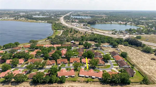 an aerial view of a city with lots of residential buildings ocean and mountain view in back
