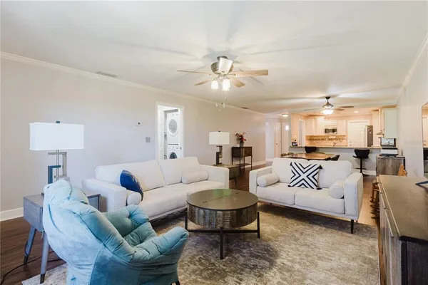 a living room with furniture and a chandelier