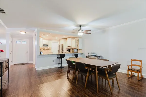 a view of a dining room with furniture and wooden floor