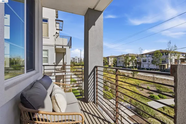 a view of balcony with two chairs and a rug