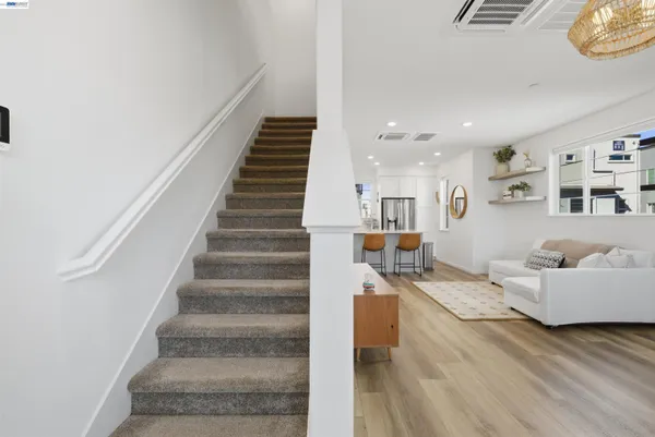 a living room with furniture and stairs