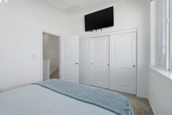 a bedroom with a flat screen tv