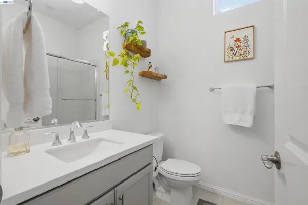 a bathroom with a sink mirror and toilet