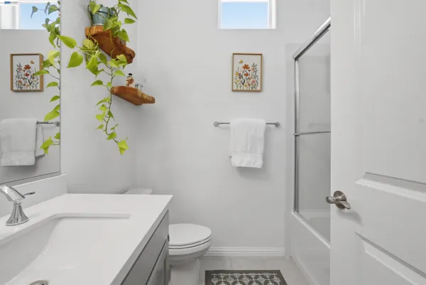 a bathroom with a sink mirror vanity and toilet