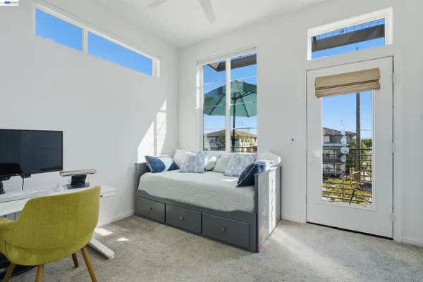 a bedroom with a bed and glass window