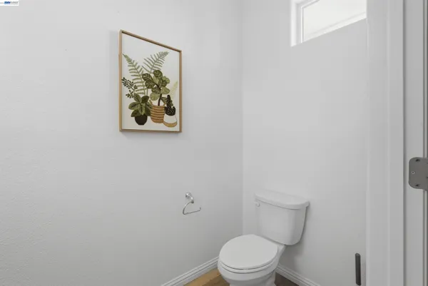 a white toilet sitting next to a white walls