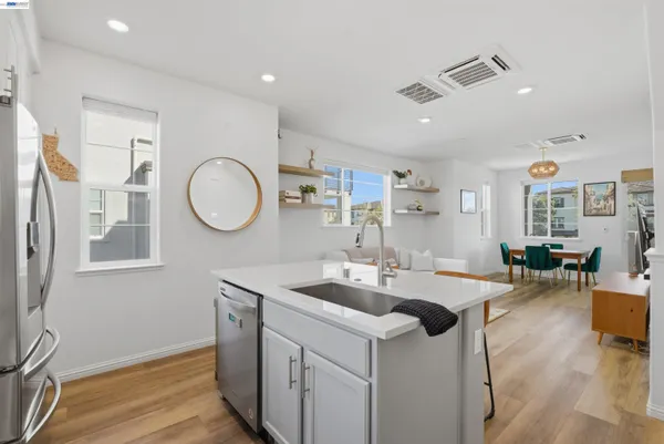 a kitchen with a sink cabinets and wooden floor