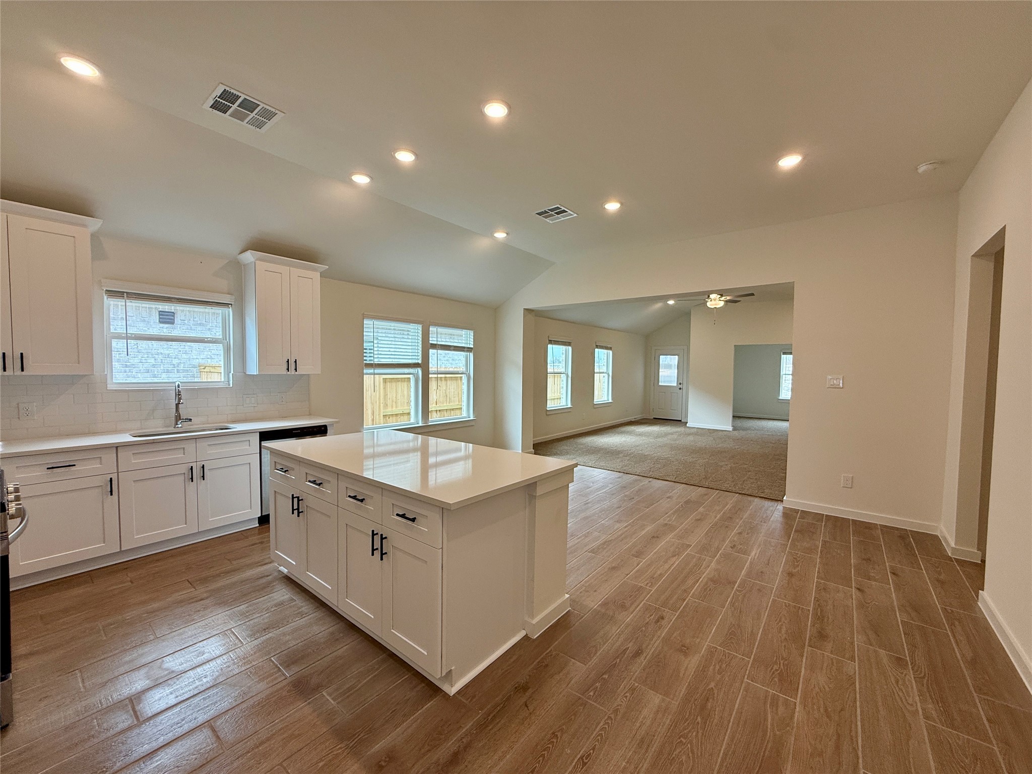 3218 Emerald Hills Drive Angleton, TX 77515 - Photo 3 of 7 a large kitchen with stainless steel appliances granite countertop a lot of counter space and wooden floors