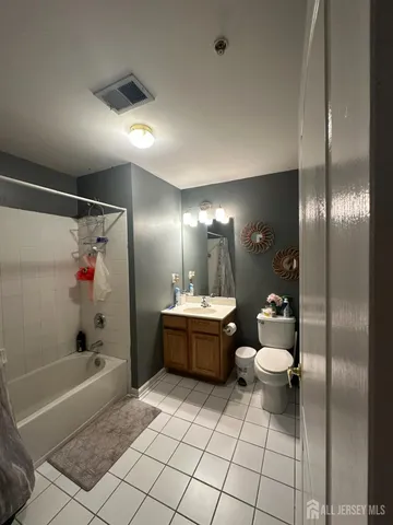 a bathroom with a bathtub shower sink and toilet