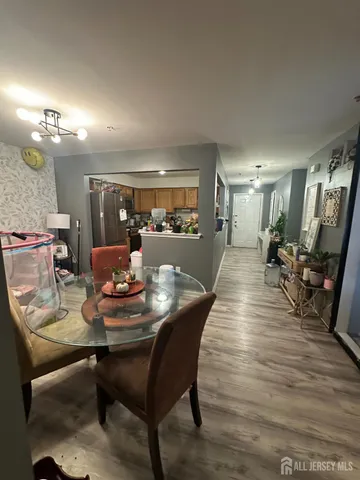 a dining room with furniture and wooden floor
