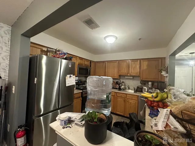 a kitchen with sink refrigerator and outdoor seating