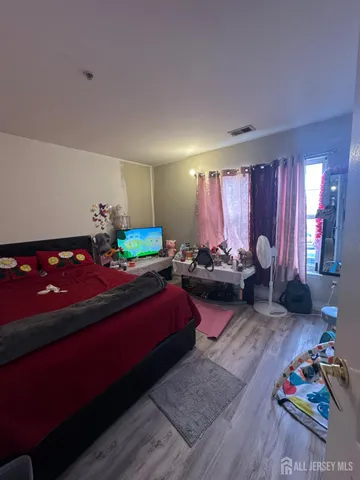 a bedroom with furniture and a large window