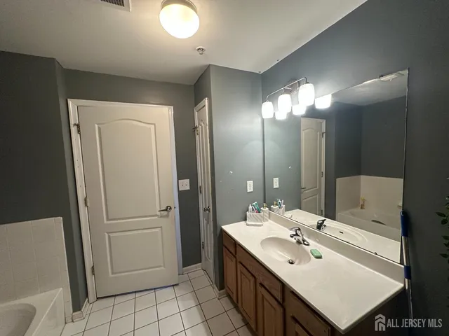 a bathroom with a sink mirror and a shower