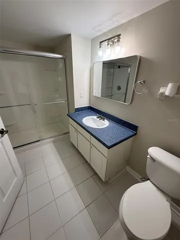 a bathroom with a toilet and a mirror