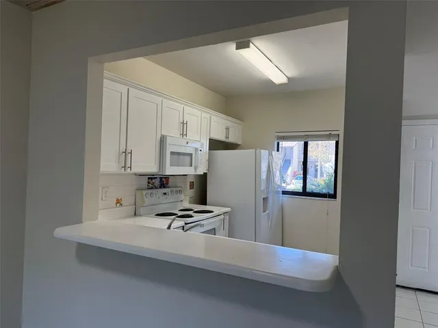 a kitchen with stainless steel appliances a refrigerator and cabinets