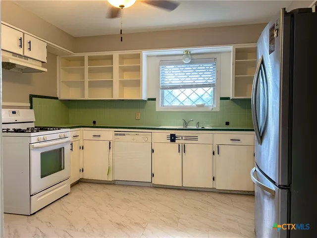 a view of a kitchen with washer and dryer