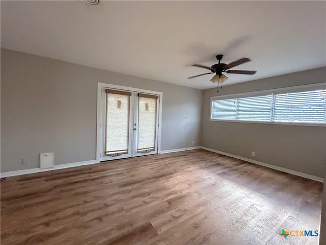 a view of an empty room with a window