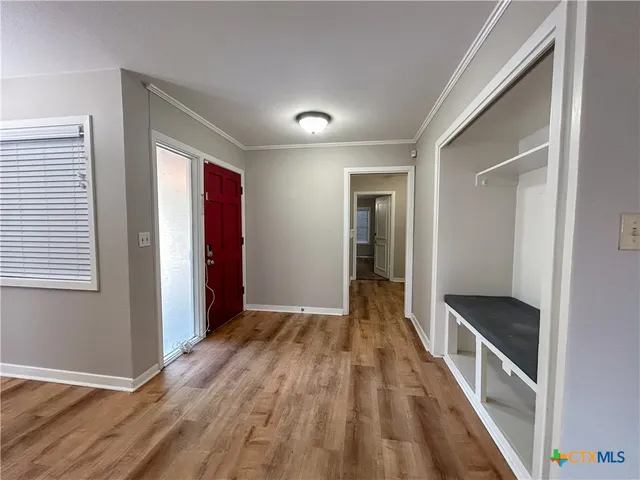 a view of hallway with wooden floor