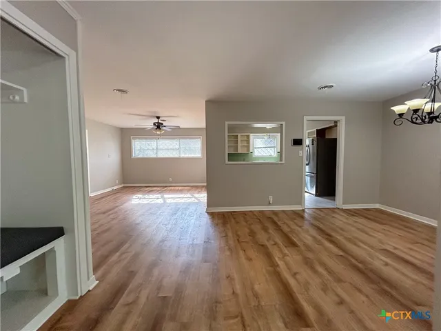 a view of wooden floor and windows in a room