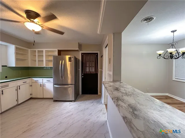 a kitchen with a refrigerator and a sink