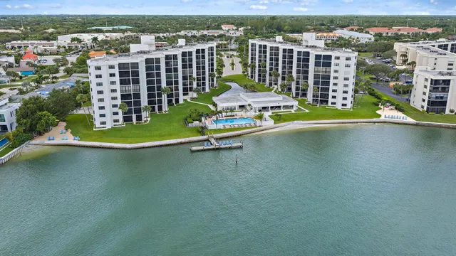 an aerial view of a house with a garden and lake view