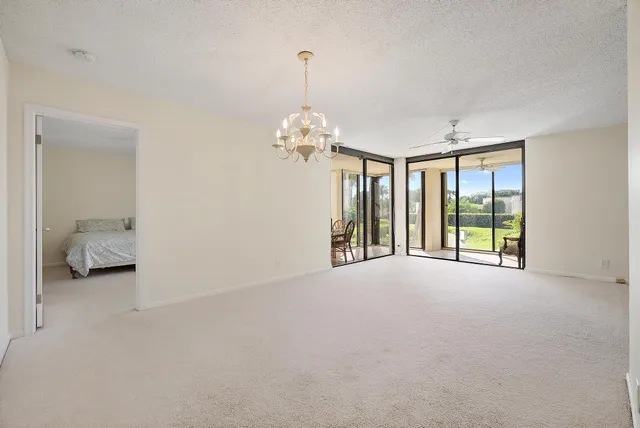 a furnished livingroom with windows and a chandelier