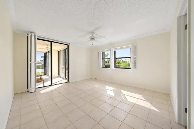 an empty room with windows and closet