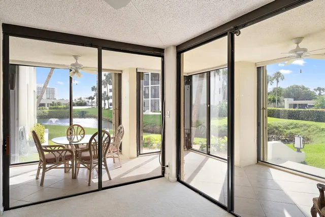 a view of room with furniture and large windows