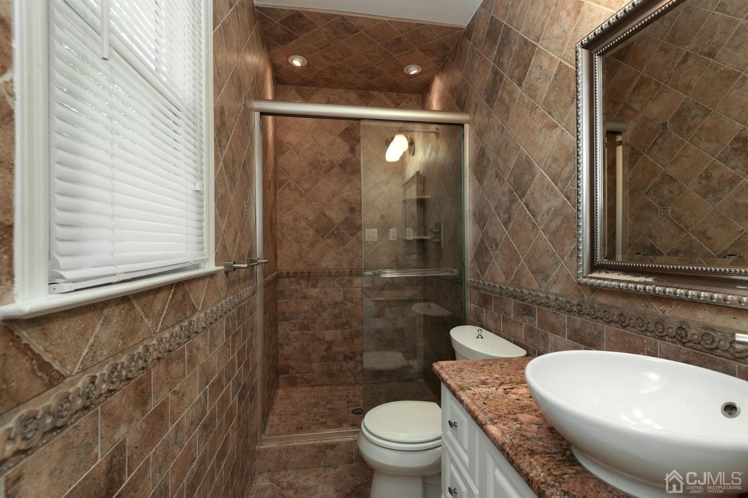 26 Donald Road East Brunswick, NJ 08816 - Photo 11 of 27 a bathroom with a toilet and a sink
