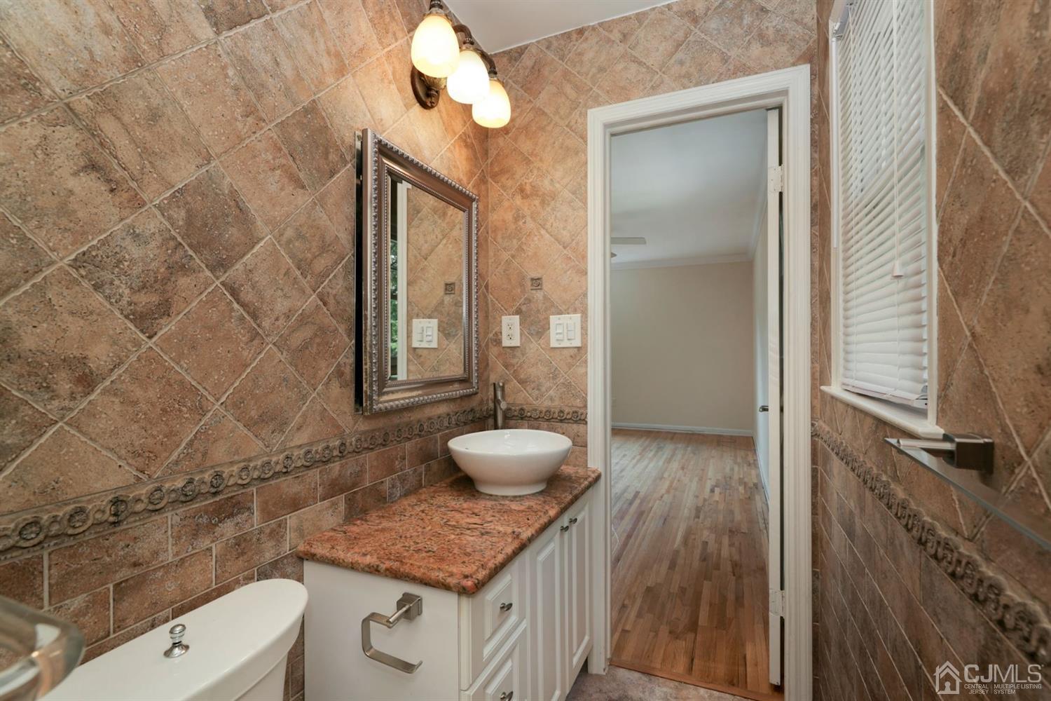 26 Donald Road East Brunswick, NJ 08816 - Photo 12 of 27 a bathroom with a granite countertop sink a toilet and shower