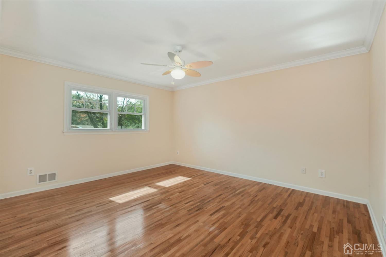 26 Donald Road East Brunswick, NJ 08816 - Photo 14 of 27 an empty room with wooden floor and windows