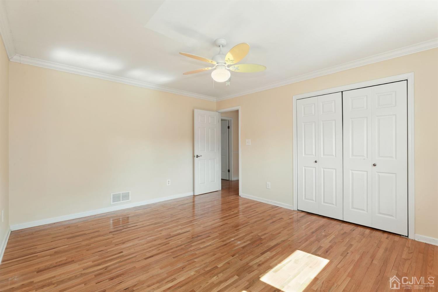 26 Donald Road East Brunswick, NJ 08816 - Photo 15 of 27 a view of an empty room with wooden floor and a ceiling fan