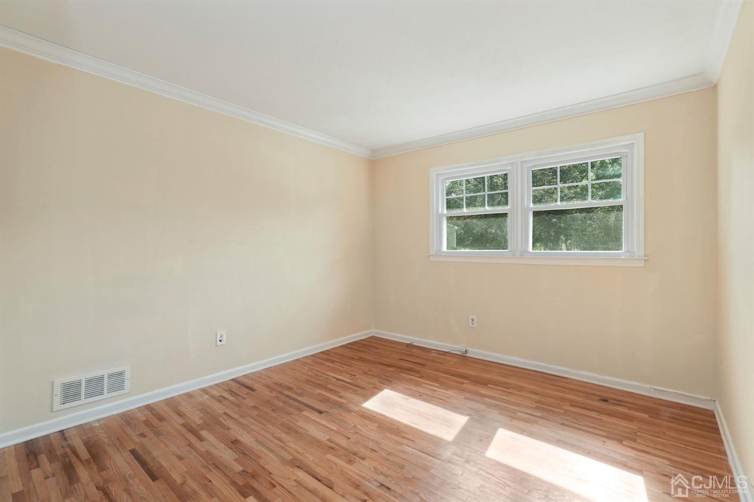 26 Donald Road East Brunswick, NJ 08816 - Photo 16 of 27 a view of a room with a wooden floor and windows