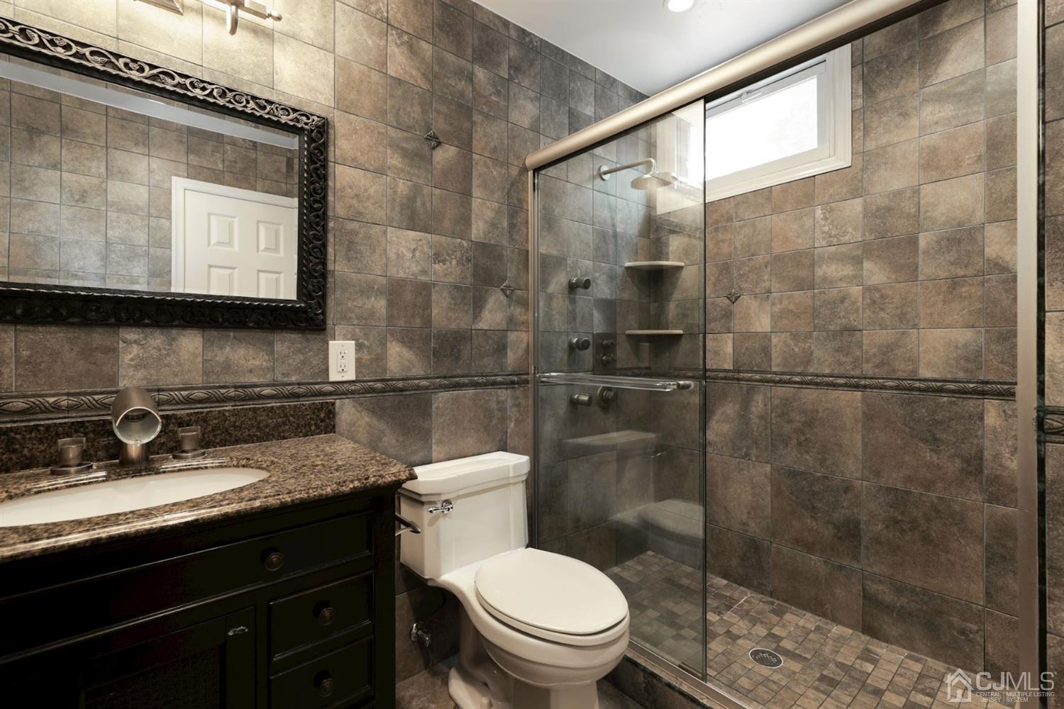 26 Donald Road East Brunswick, NJ 08816 - Photo 18 of 27 a bathroom with a granite countertop sink toilet and shower