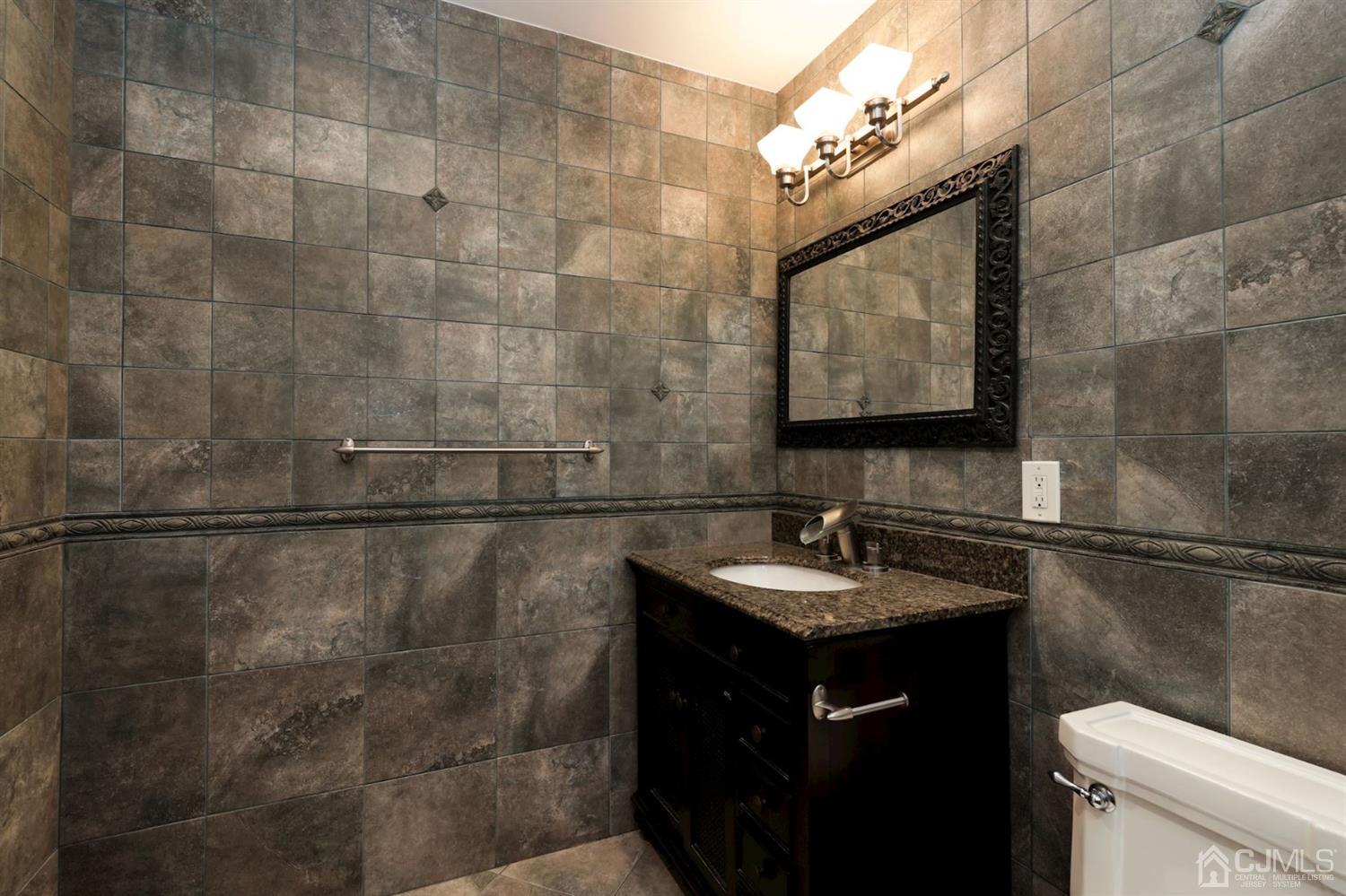 26 Donald Road East Brunswick, NJ 08816 - Photo 19 of 27 a bathroom with a sink and a mirror