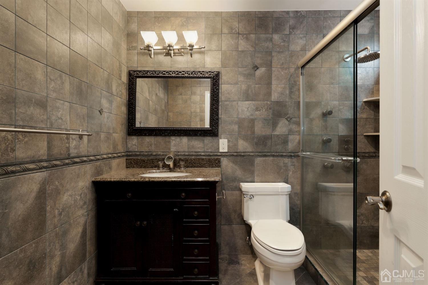 26 Donald Road East Brunswick, NJ 08816 - Photo 20 of 27 a bathroom with a toilet sink and mirror