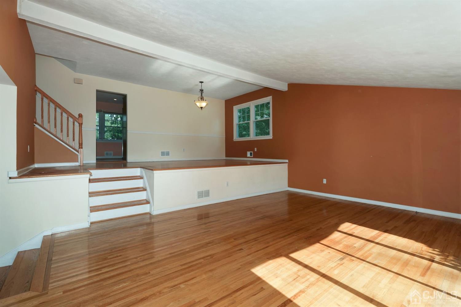 26 Donald Road East Brunswick, NJ 08816 - Photo 3 of 27 a view of an empty room with wooden floor and a window