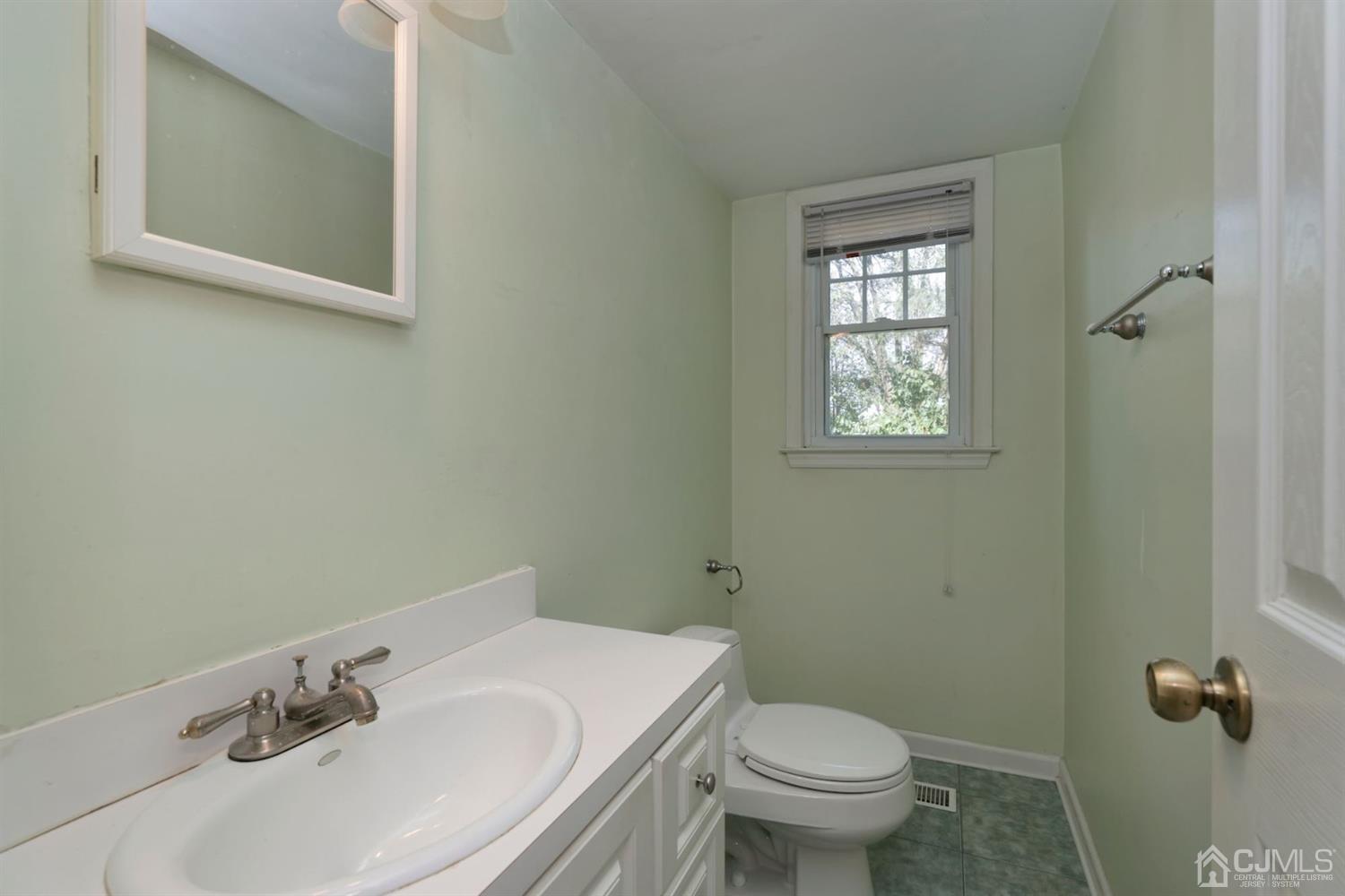 26 Donald Road East Brunswick, NJ 08816 - Photo 23 of 27 a bathroom with a sink toilet and a mirror