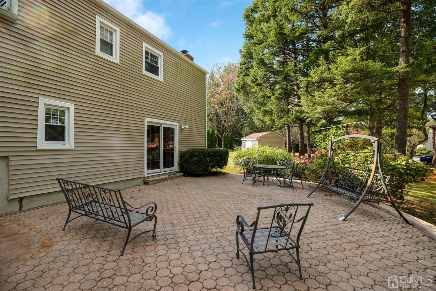 26 Donald Road East Brunswick, NJ 08816 - Photo 25 of 27 a backyard of a house with table and chairs