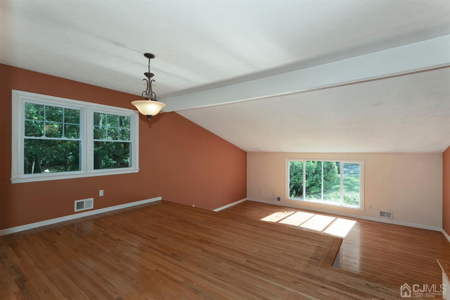 26 Donald Road East Brunswick, NJ 08816 - Photo 4 of 27 a view of an empty room with wooden floor and a window