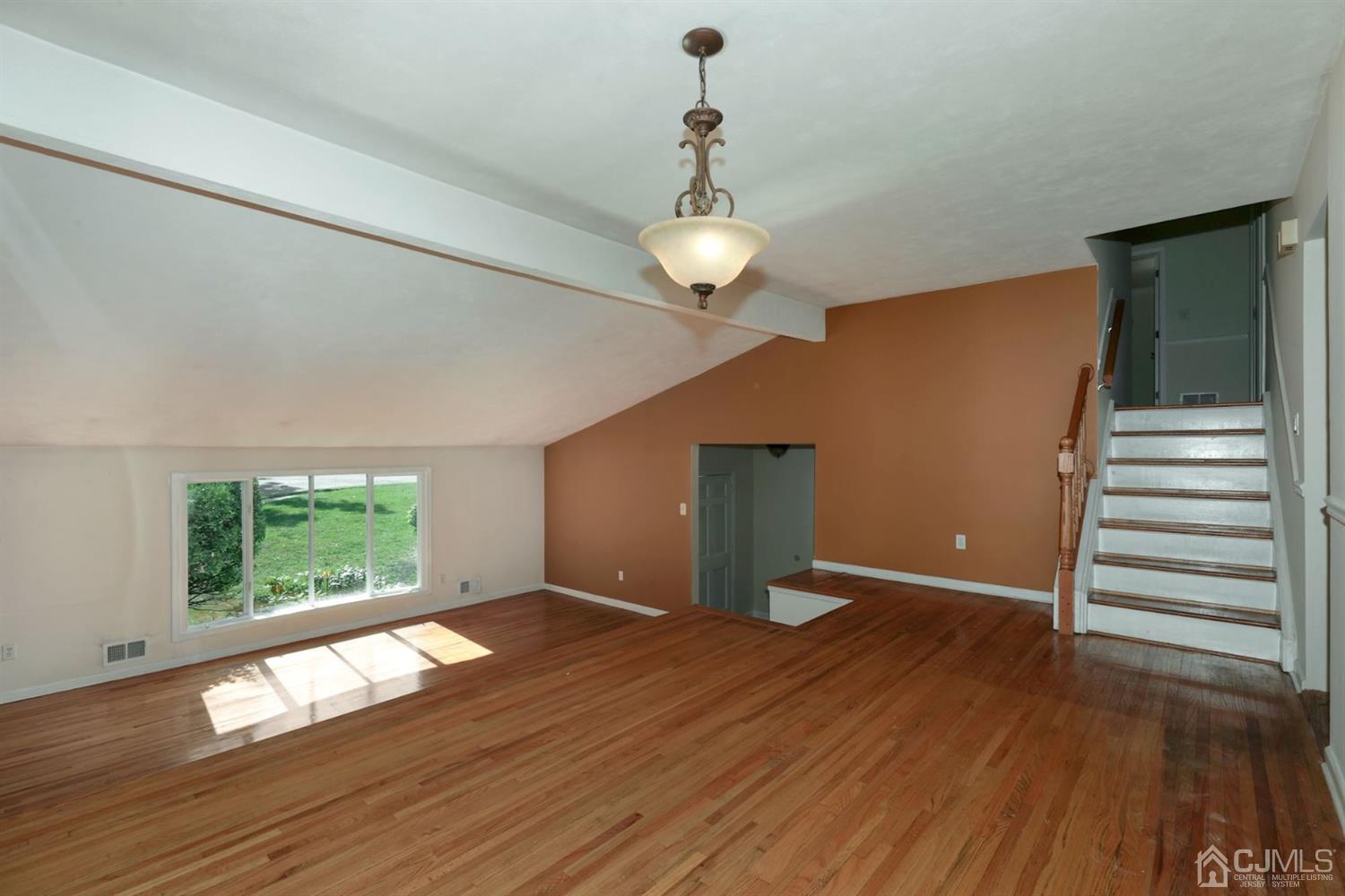 26 Donald Road East Brunswick, NJ 08816 - Photo 5 of 27 a view of an empty room with wooden floor and a window