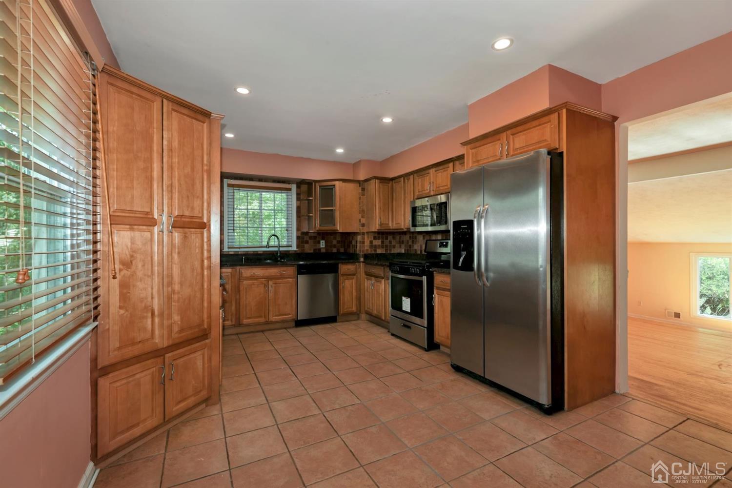 26 Donald Road East Brunswick, NJ 08816 - Photo 7 of 27 a kitchen with stainless steel appliances granite countertop a refrigerator and a sink