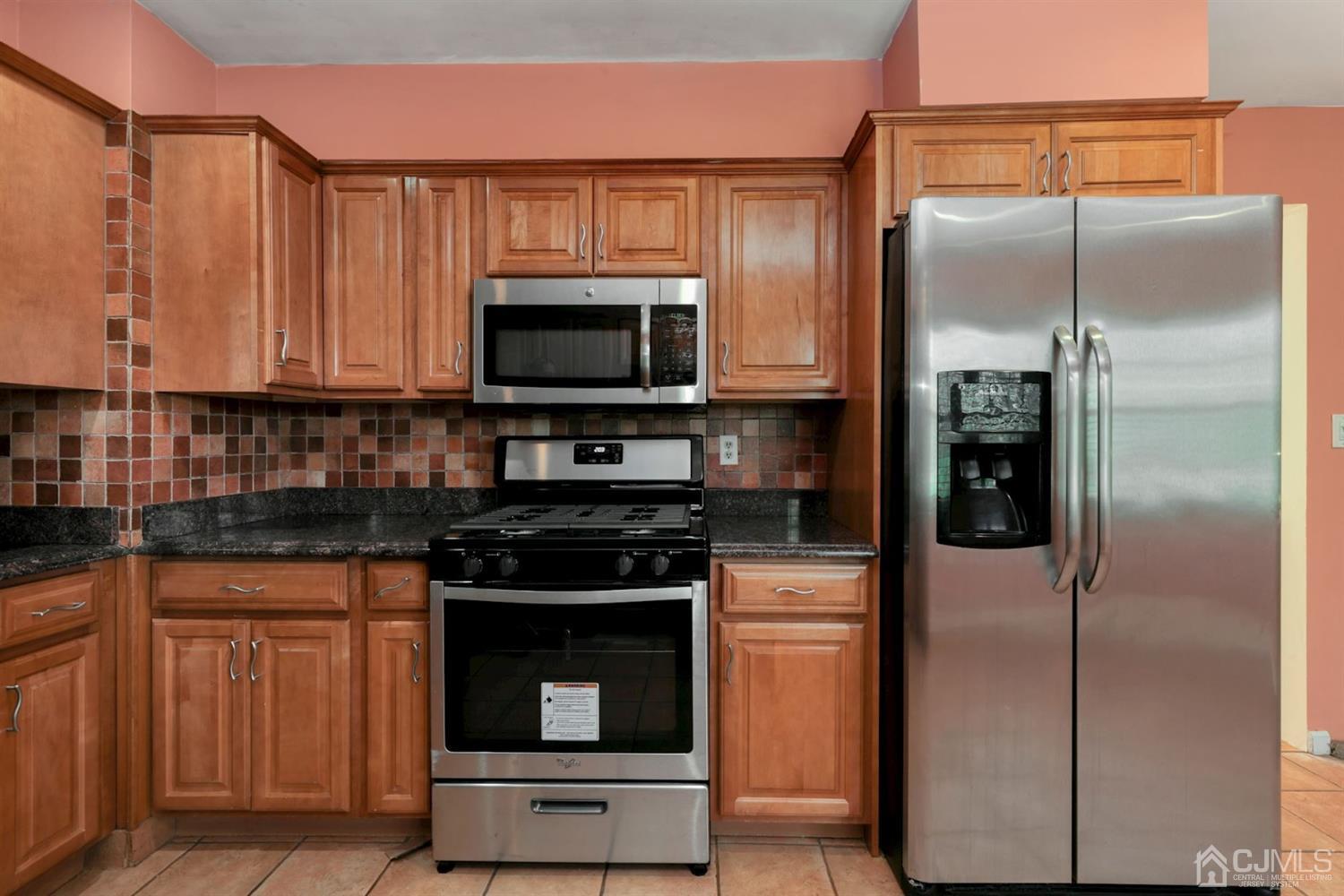 26 Donald Road East Brunswick, NJ 08816 - Photo 8 of 27 a kitchen with appliances a refrigerator and cabinets