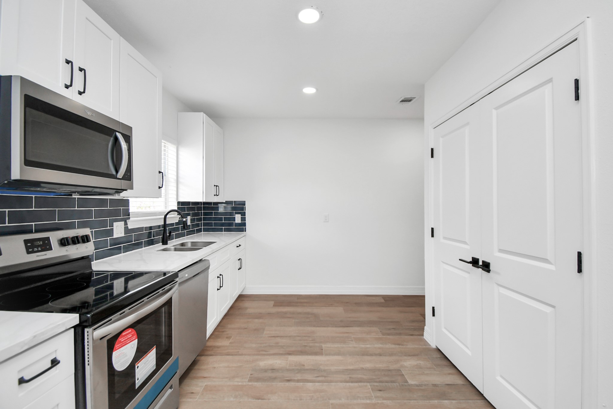 2812 Truxillo Street, Unit B Houston, TX 77004 - Photo 17 of 32 a kitchen with a sink stove and microwave