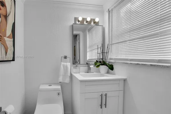 a bathroom with a sink a toilet and mirror