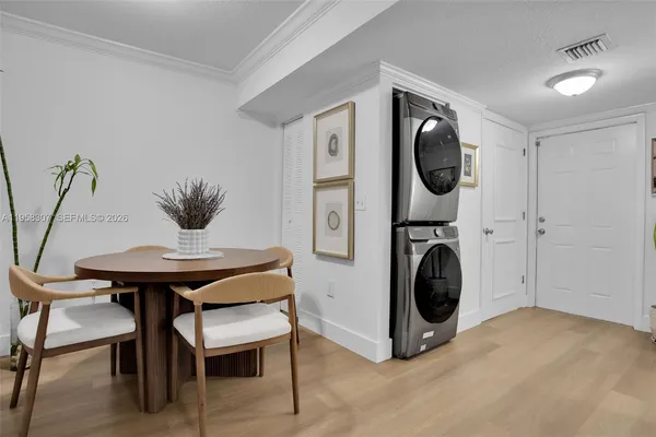 a view of a dining room with furniture and a washer dryer