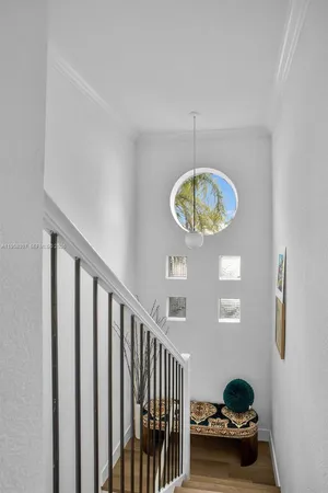 a view of a room with a chandelier and window