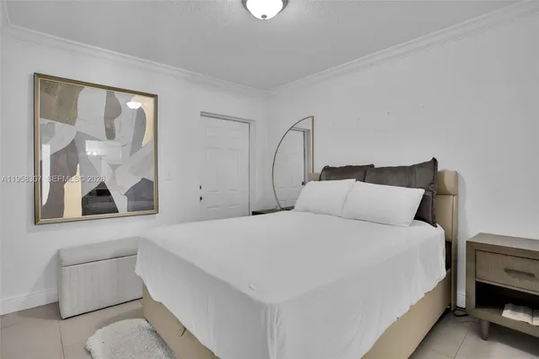 a bedroom with a bed and a painting on the wall