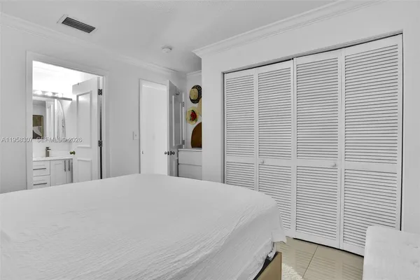 a large white bed in a white room